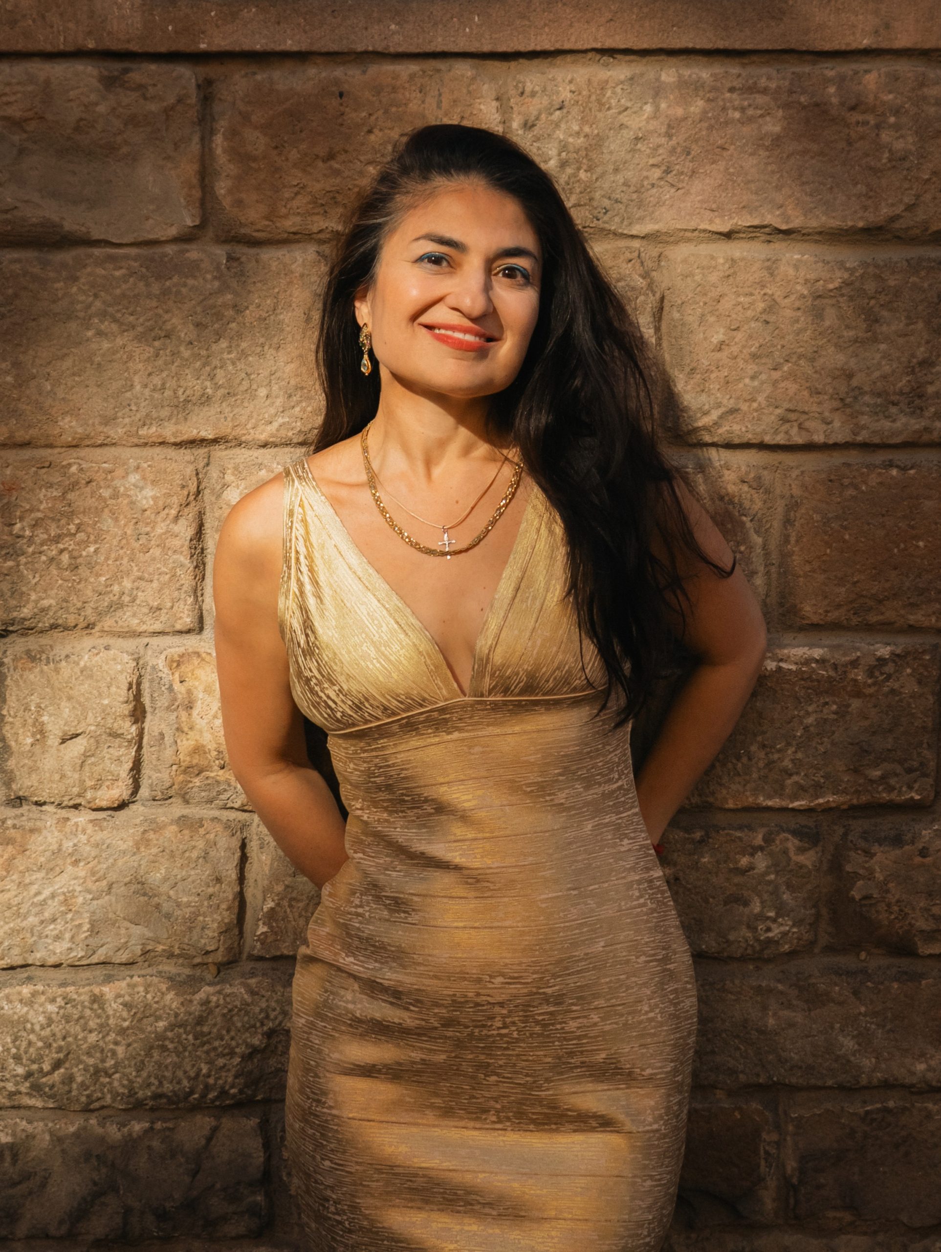 Lola Ganzarolli in a gold dress